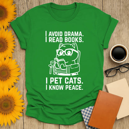 Cozy green cat reading shirt with witty text: 'I avoid drama. I read books. I pet cats. I know peace.' Perfect for book lovers!
