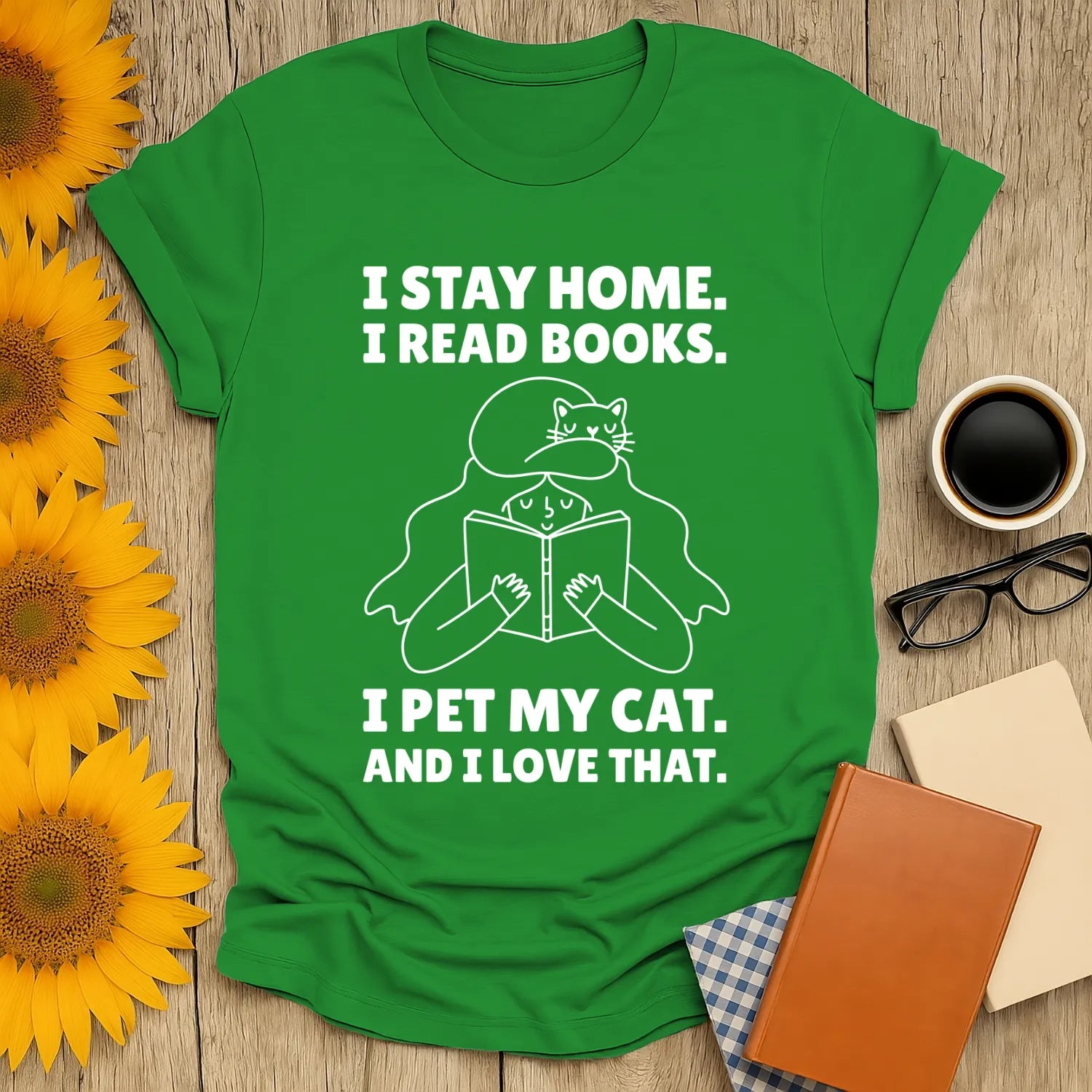 Green unisex tee with text: 'I stay home. I read books. I pet my cat. And I love that.' Perfect for cozy book lovers and cat enthusiasts.