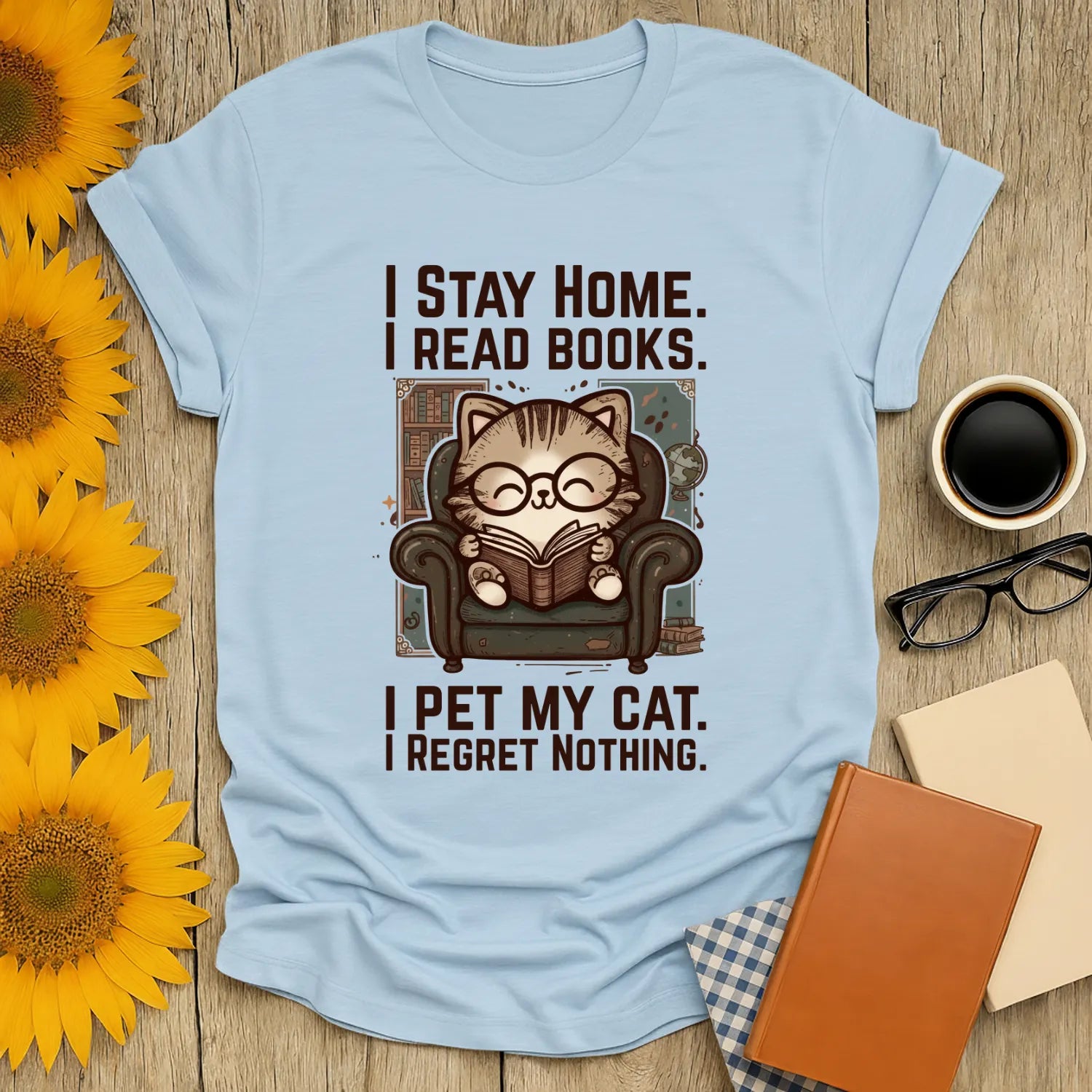 Library Cat Reader T-Shirt featuring a cozy cat in glasses reading in an armchair with bookish humor text, perfect for cat-loving bookworms.