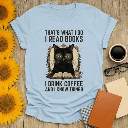 Coffee Cat Reader T-Shirt featuring a black cat in glasses, sipping coffee, reading a book, and saying funny literary quotes.