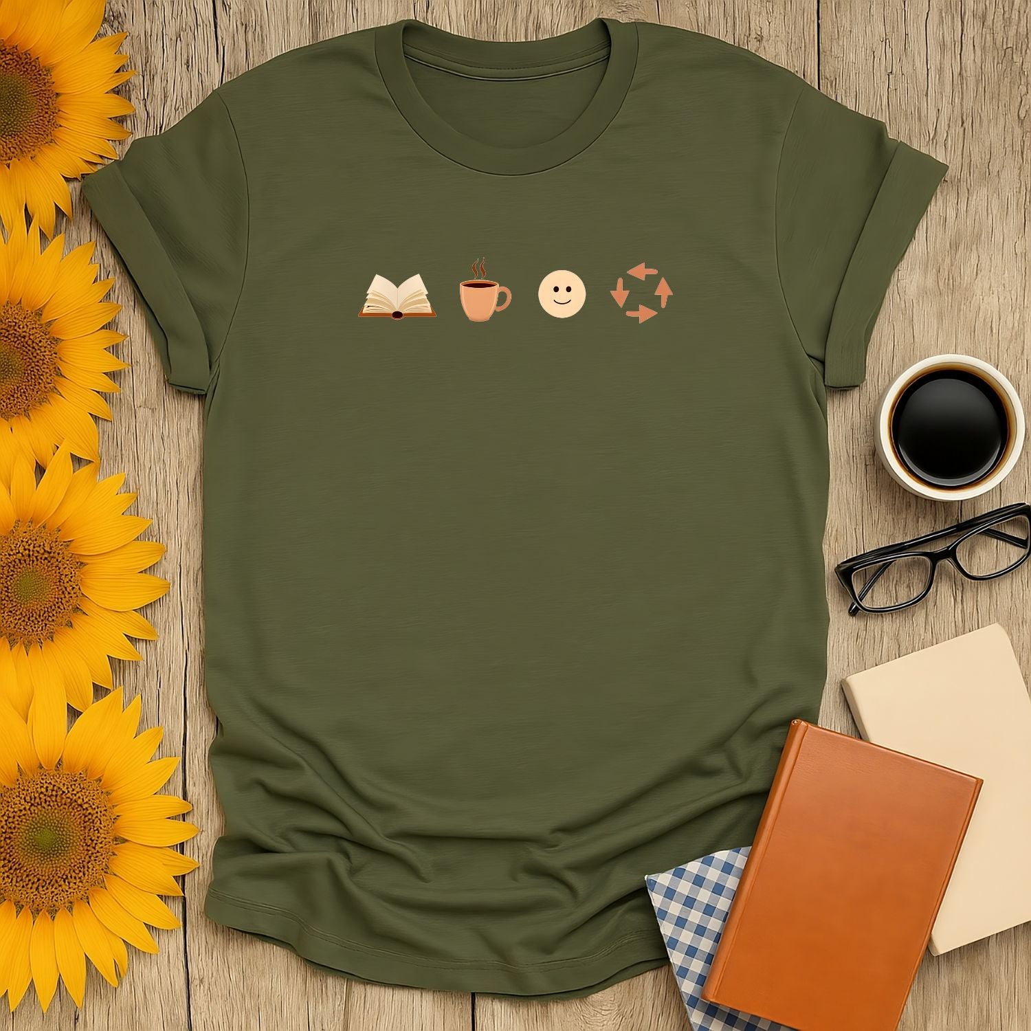 A cozy olive green t-shirt featuring icons of a book, coffee cup, smiley face, and arrows, perfect for book lovers.