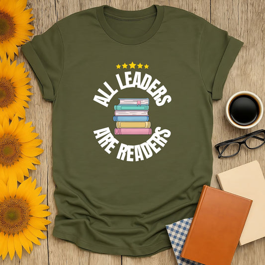 Cozy book lover shirt with stacked books and 'All Leaders Are Readers' text, perfect gift for cat and coffee fans.