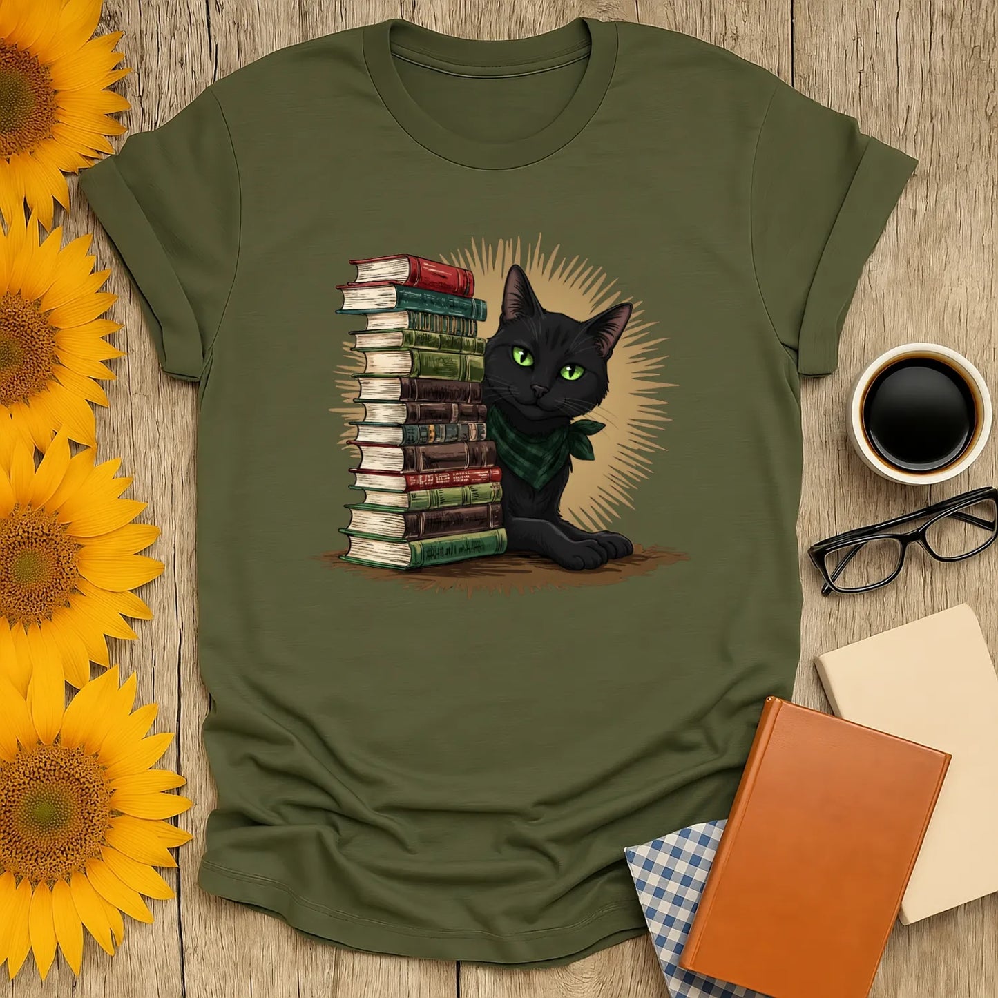 Library Sentinel T-Shirt featuring a black cat with green eyes beside a stack of books, evoking a cozy reading atmosphere.