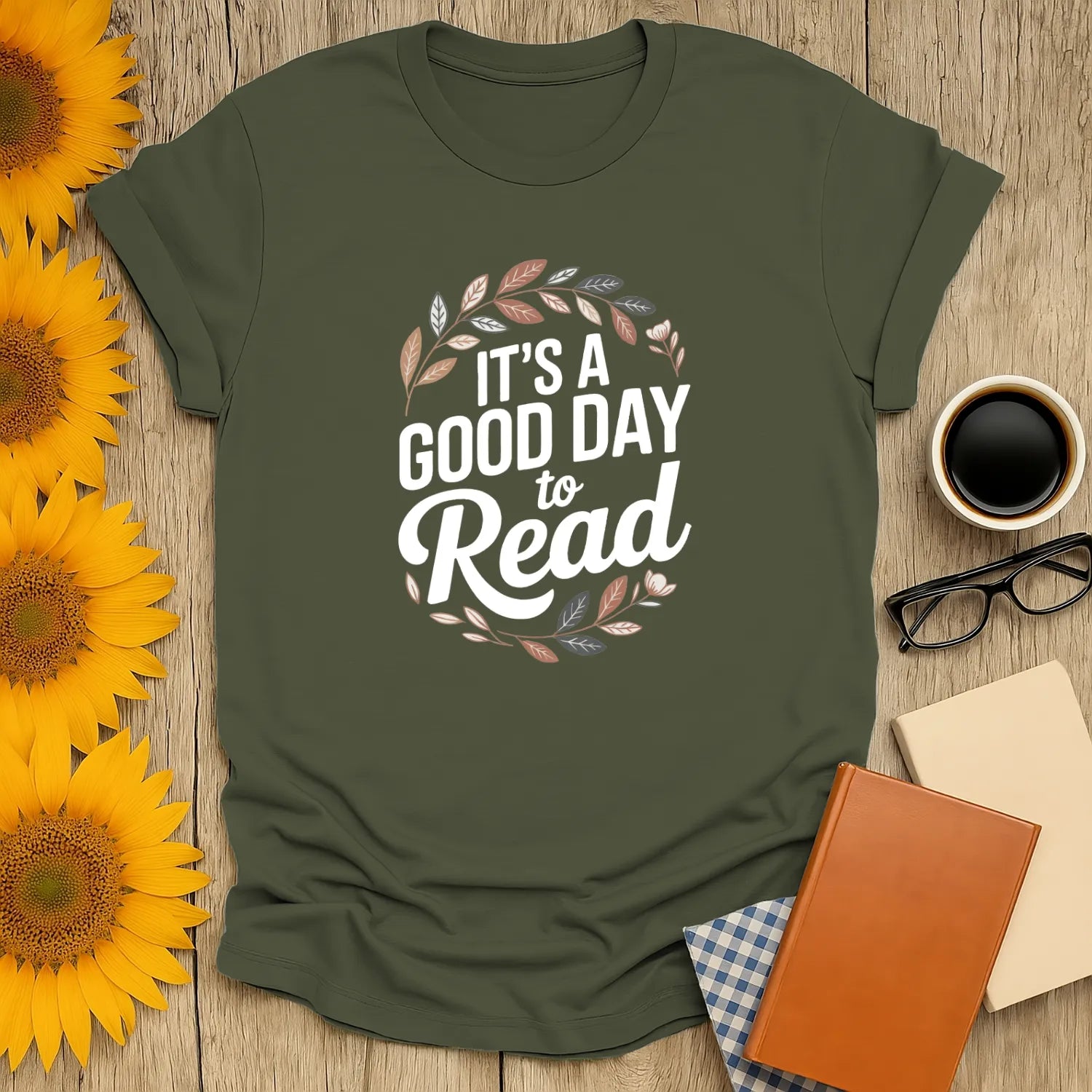 Cozy green tee with 'It's a Good Day to Read' and decorative leaves, perfect gift for book lovers and cat enthusiasts.