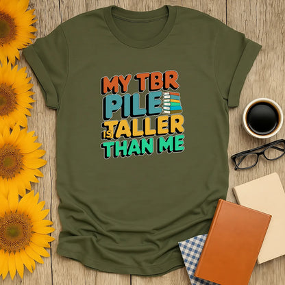 TBR Pile T-Shirt in olive green, a cozy reading outfit for book lovers, featuring bold text and a relaxed fit, perfect gift for readers ☕️.