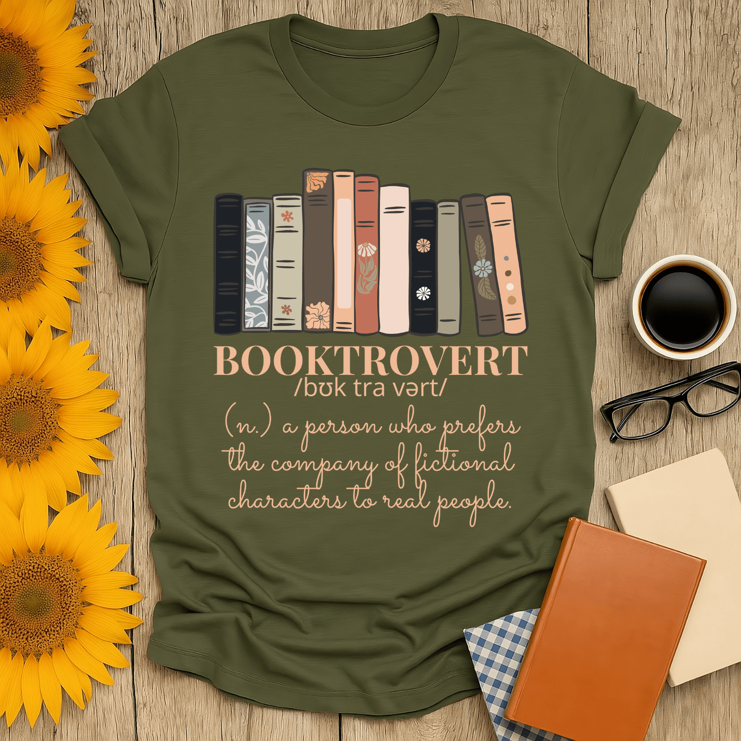 Booktrovert T-Shirt for book lovers featuring a design with books and decorative fonts on a green backdrop.