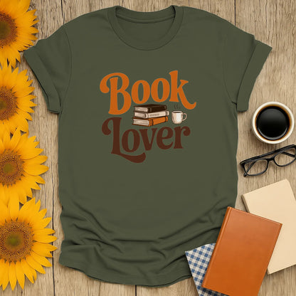 Cozy book lover shirt with playful text, stacked books, and a coffee cup—perfect gift for readers who adore cats and coffee.