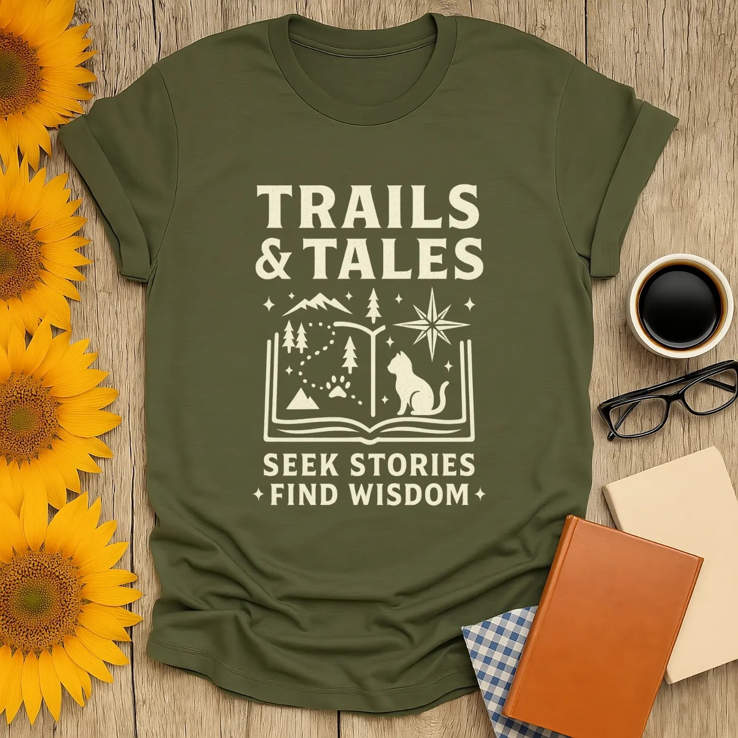 Trails & Tales T-Shirt featuring mountains, stars, and a wise cat illustration—perfect for book lovers and cozy adventures.