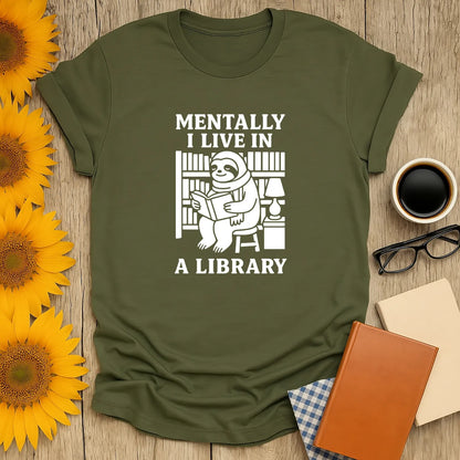 Funny bookworm t-shirt with a sloth reading among shelves, text says 'Mentally I Live in a Library,' perfect gift for readers.