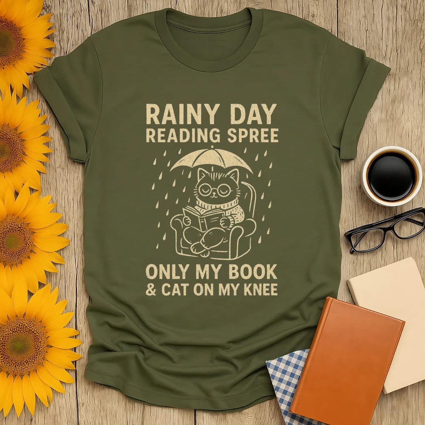Funny cat reading shirt featuring a kitty under an umbrella with the text 'Rainy Day Reading Spree'. Perfect for book lovers!