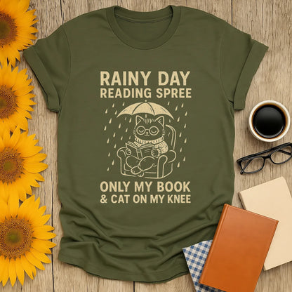 Funny cat reading shirt featuring a kitty under an umbrella with the text 'Rainy Day Reading Spree'. Perfect for book lovers!
