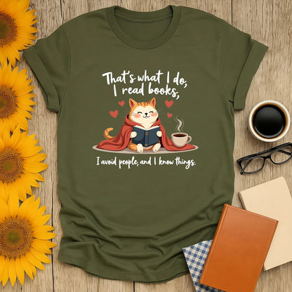 Cozy cat in a cape reading a book with coffee, says 'That's what I do, I read books.' Perfect for book lovers!