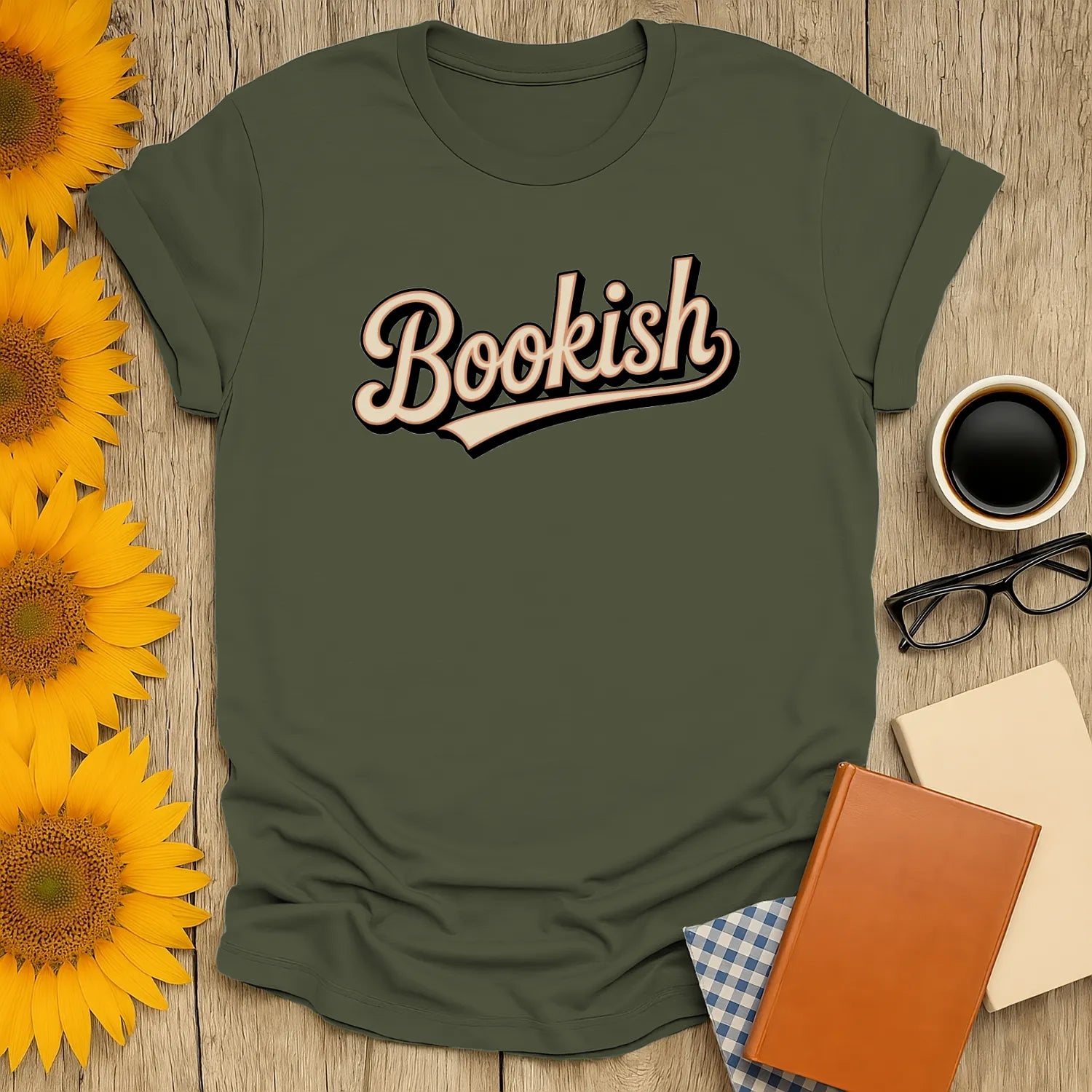 Cozy green Bookish t-shirt with playful script, perfect for book lovers, paired with books and a coffee cup.