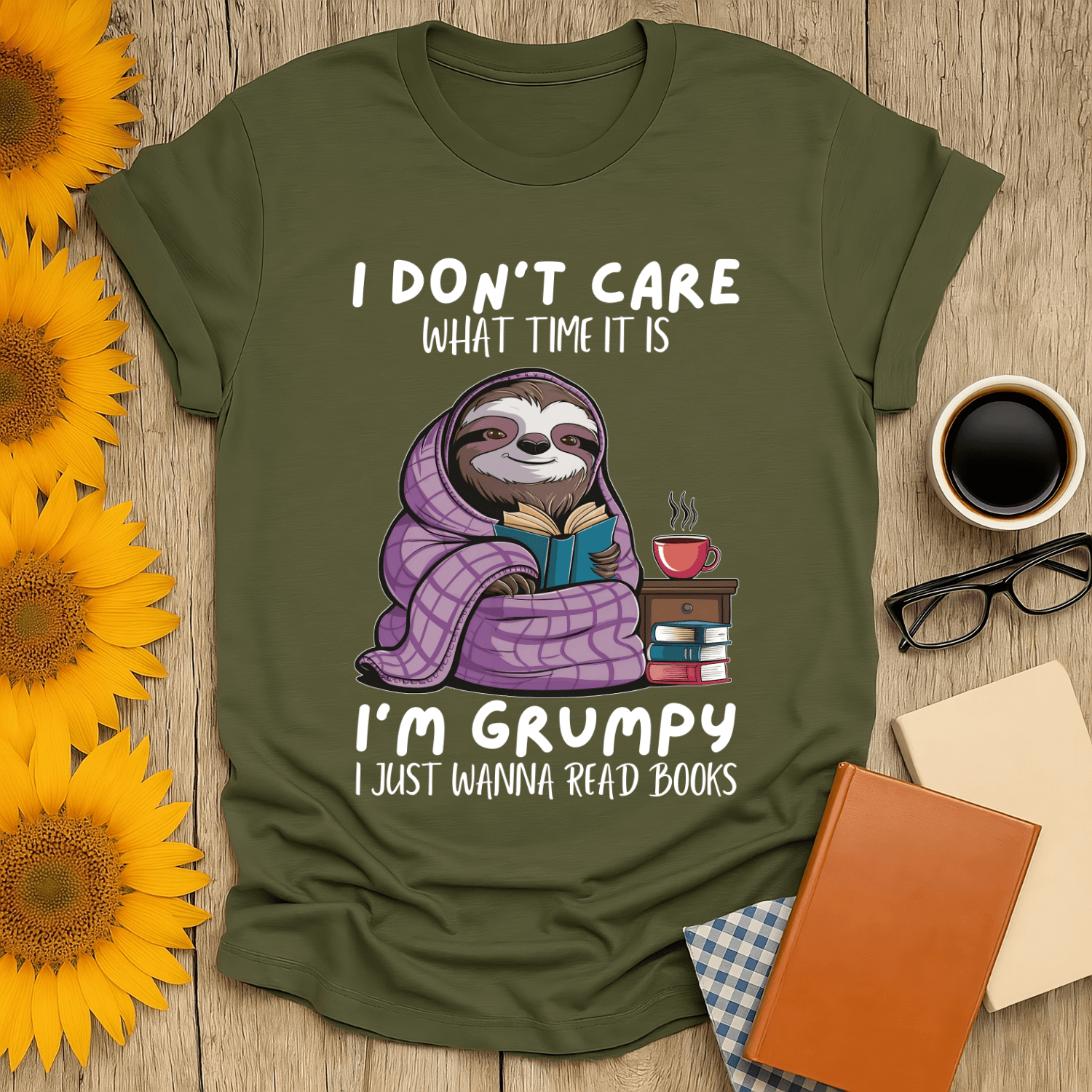 Grumpy sloth book lover t-shirt, featuring cozy sloth reading with books and coffee, perfect for book enthusiasts.