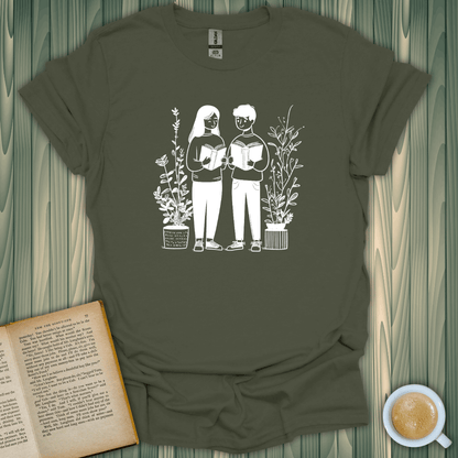 Bookish Buddies T-Shirt featuring two readers surrounded by plants, perfect for book lovers. Made of soft ring-spun cotton.