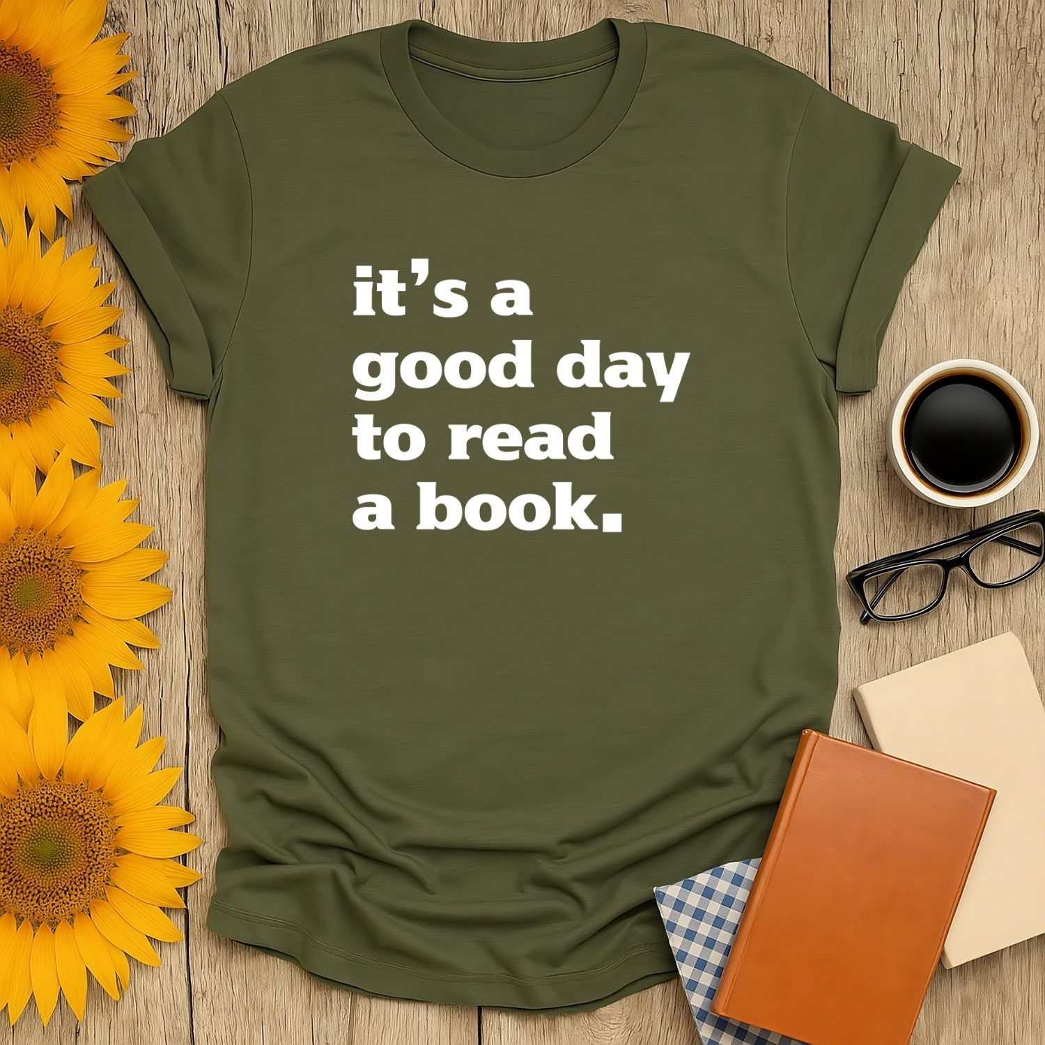 Cozy book lover shirt with witty text: 'it's a good day to read a book.' Perfect gift for readers who enjoy cats, coffee, or tea.
