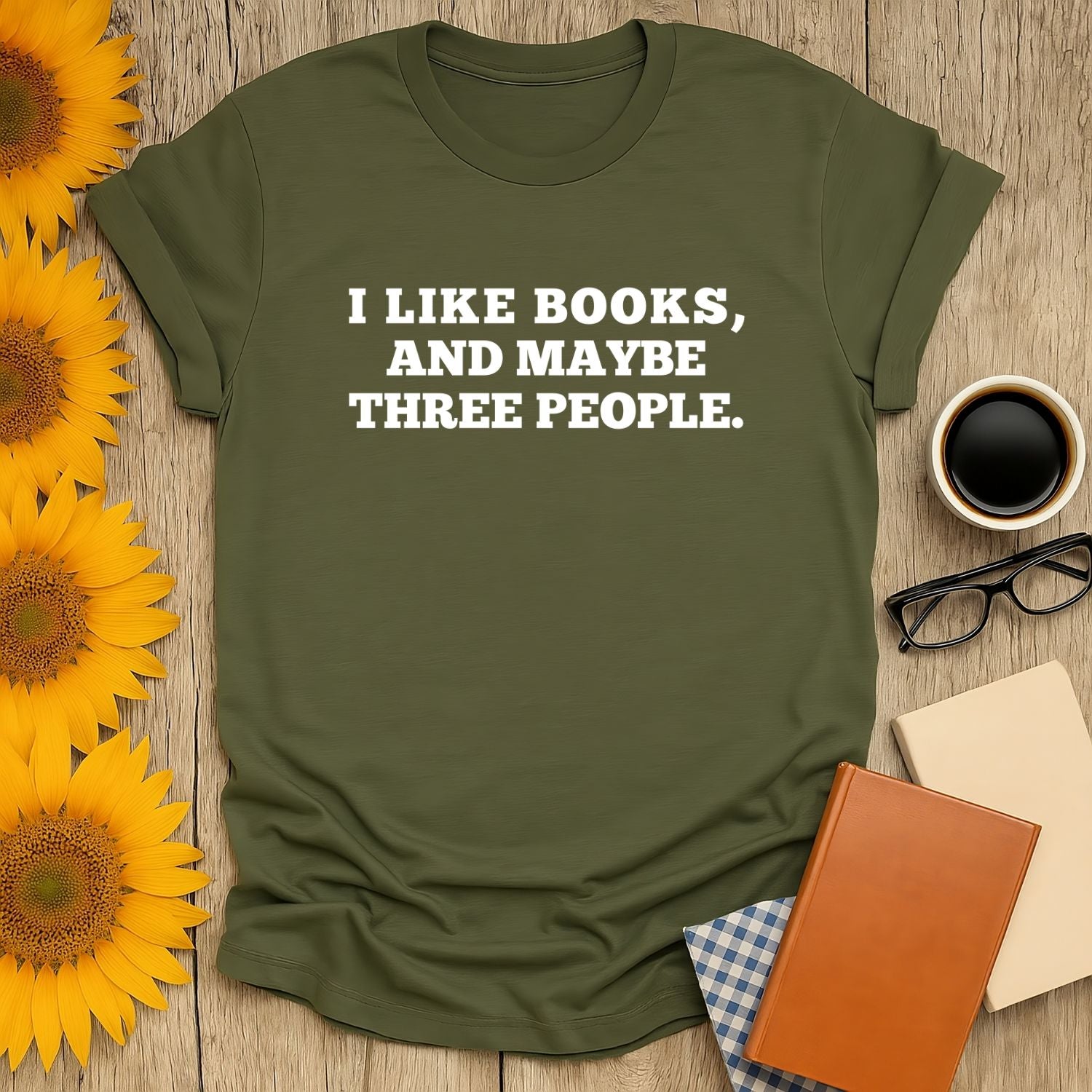 Bookish humor tee with the text 'I LIKE BOOKS, AND MAYBE THREE PEOPLE.' Perfect for cozy readers who love cats and coffee.