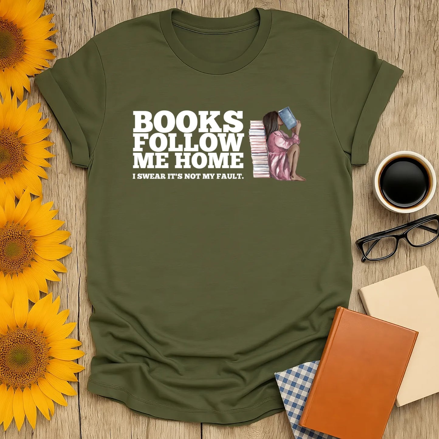 Funny book lover t-shirt with a cozy design: a cat reading, saying 'Books follow me home, I swear it's not my fault.'