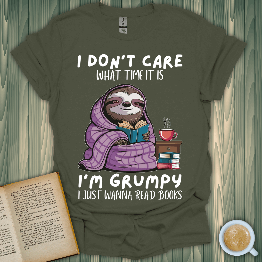 Grumpy sloth book lover t-shirt featuring a cozy sloth reading with a cup of coffee, perfect for book enthusiasts.