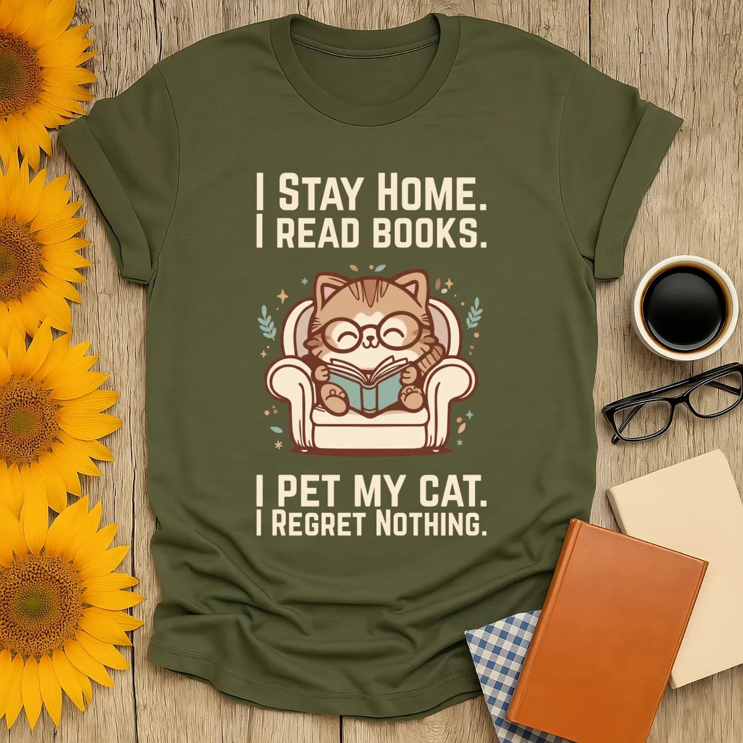 Homebody Cat Reader T-Shirt featuring a cute cat in glasses on a couch reading a book, with a cozy message for book lovers.