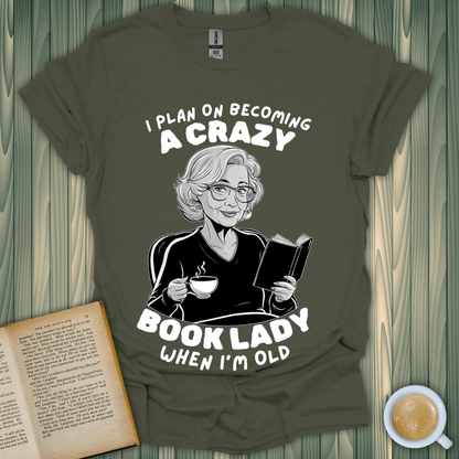 Funny Crazy Book Lady T-Shirt for book lovers featuring an older woman enjoying tea and reading.