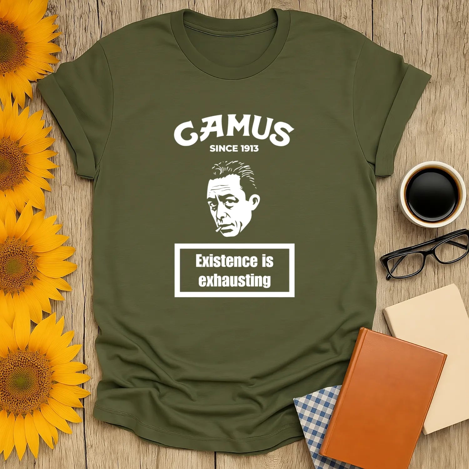 Olive green Camus Energy Level T-Shirt featuring a thoughtful man and the phrase 'Existence is exhausting'—perfect for book lovers!