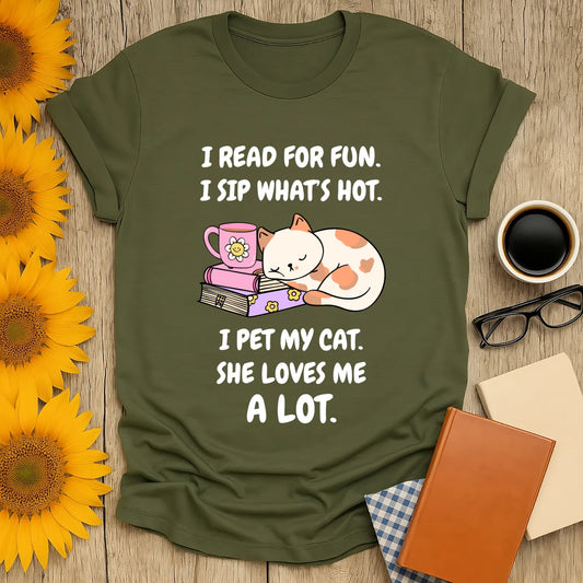 Cozy book lover shirt with a playful cat drinking tea, perfect gift for readers and cat enthusiasts.