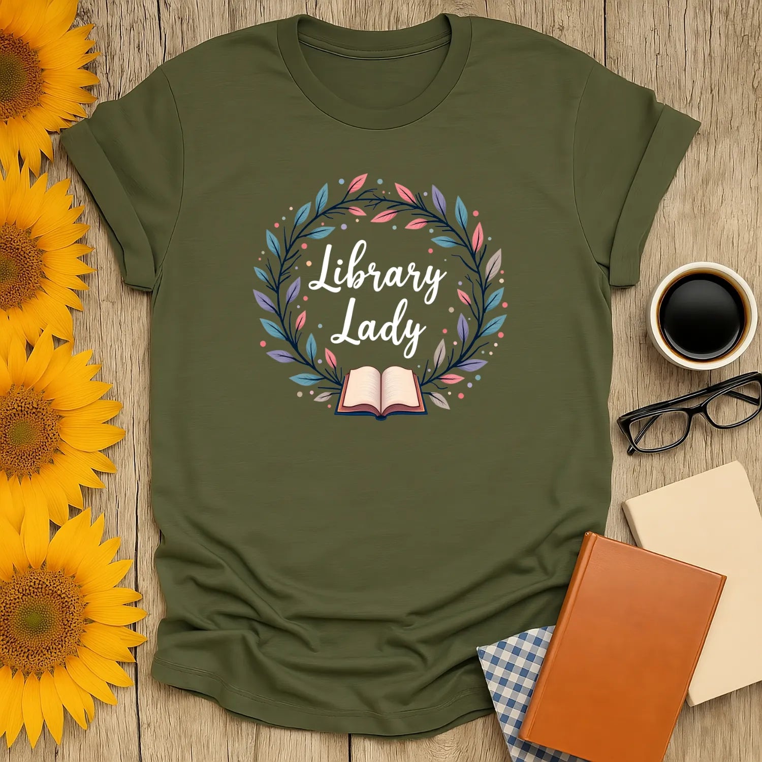 Cozy Library Lady t-shirt featuring an open book and floral wreath design, perfect gift for cat-loving readers.