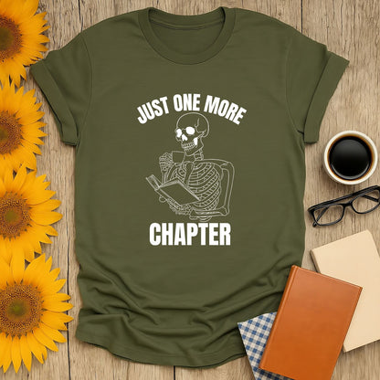 Skeleton reading with a book saying 'Just One More Chapter' on cozy green tee—perfect for book lovers and gift seekers!