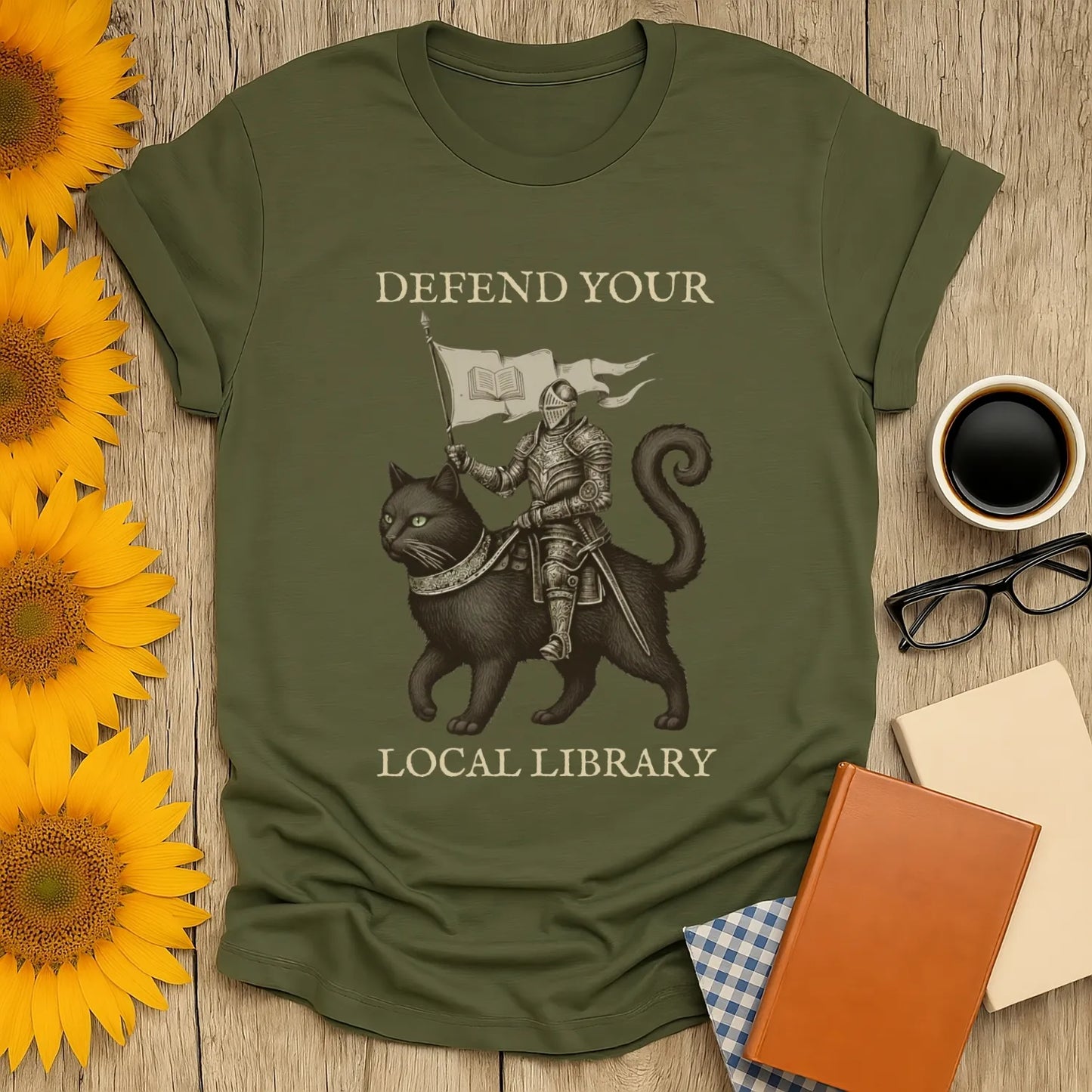 Library Defender T-Shirt featuring a knight on a heroic cat with text 'Defend Your Local Library', perfect for book lovers and gifts.