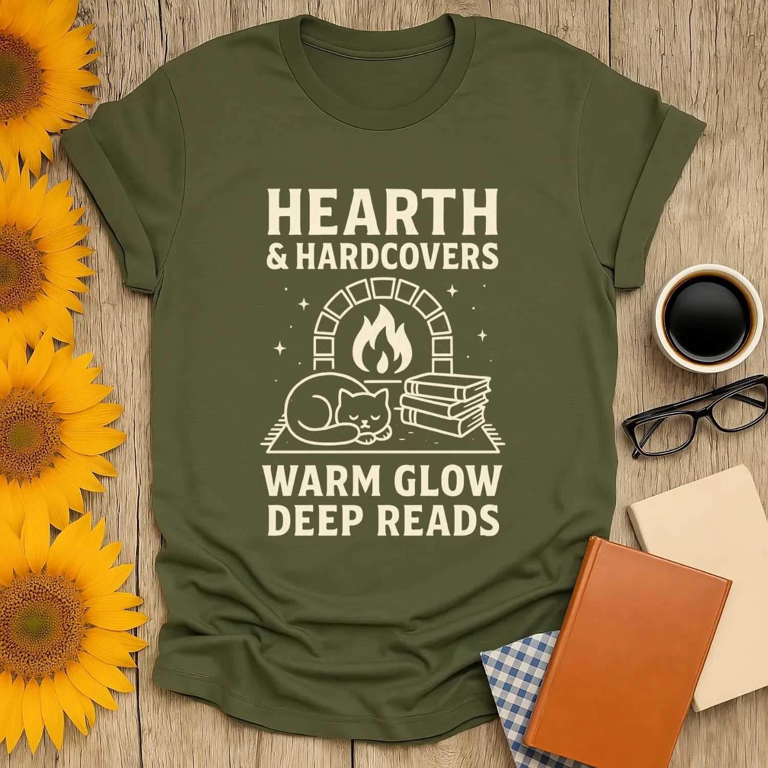 Cozy Hearth & Hardcovers t-shirt featuring a sleeping cat, fireplace, and bookish text—perfect gift for book lovers!