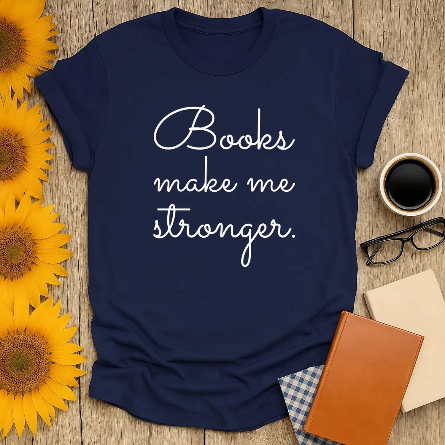Cozy navy blue tee with 'Books make me stronger' text; perfect gift for book lovers who cherish reading, coffee, and cats.