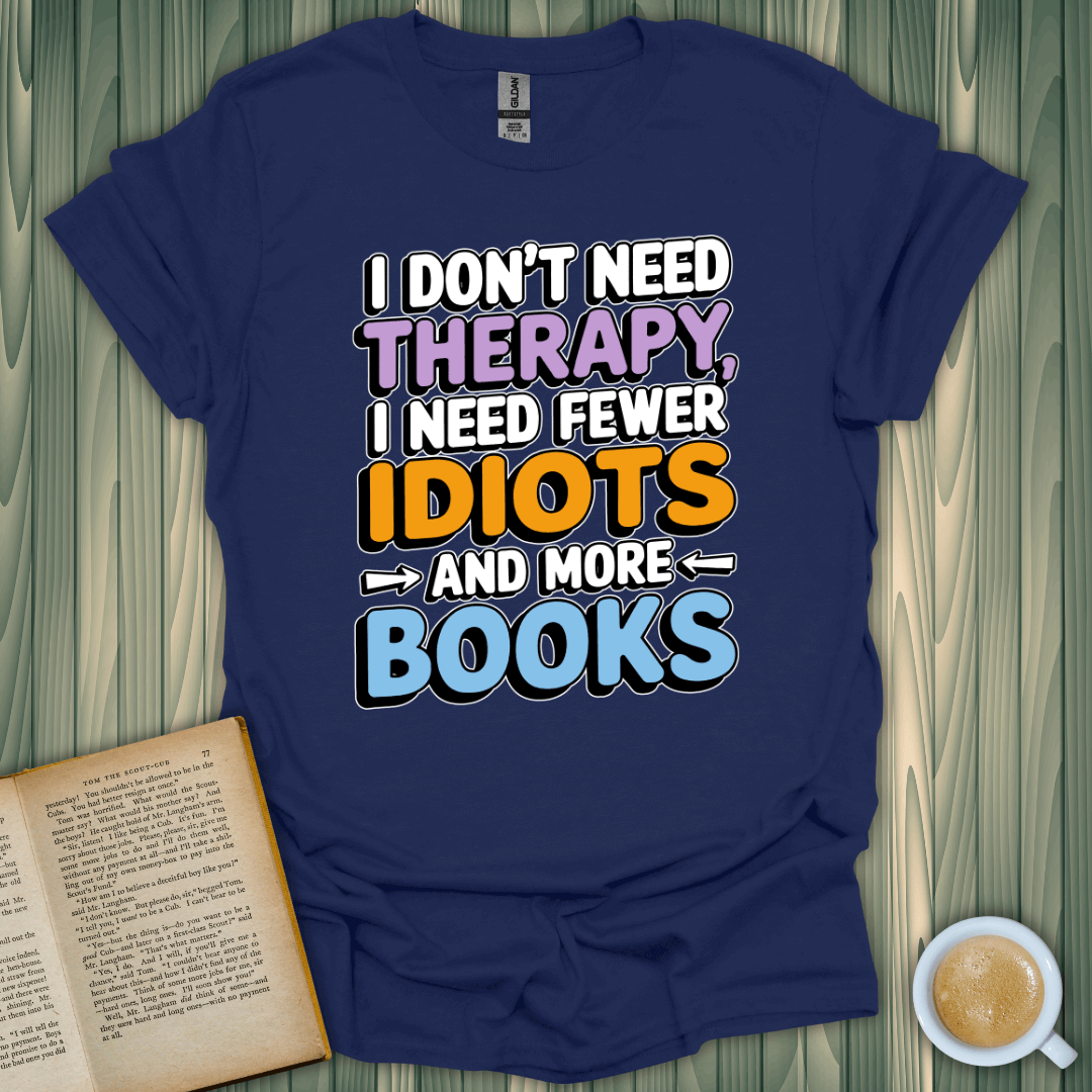 Unisex navy T-shirt with playful text: 'I don't need therapy, I need fewer idiots and more books' for book lovers.