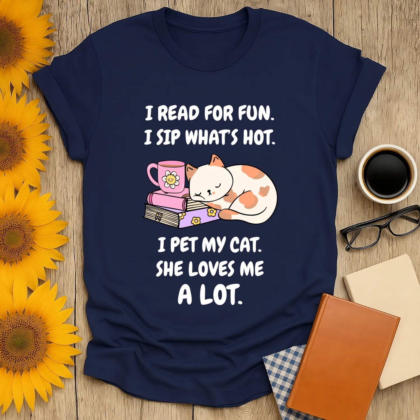 Navy t-shirt featuring cute cat, coffee cup, and playful text: 'I read for fun, I sip what's hot, I pet my cat.'