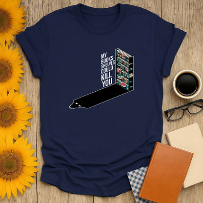 Funny reading tee with shelves of books and text: 'My bookshelves could kill you', perfect for cozy book lovers.