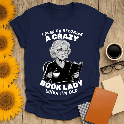 Crazy Book Lady t-shirt design featuring a woman reading while sipping tea, perfect for book lovers.