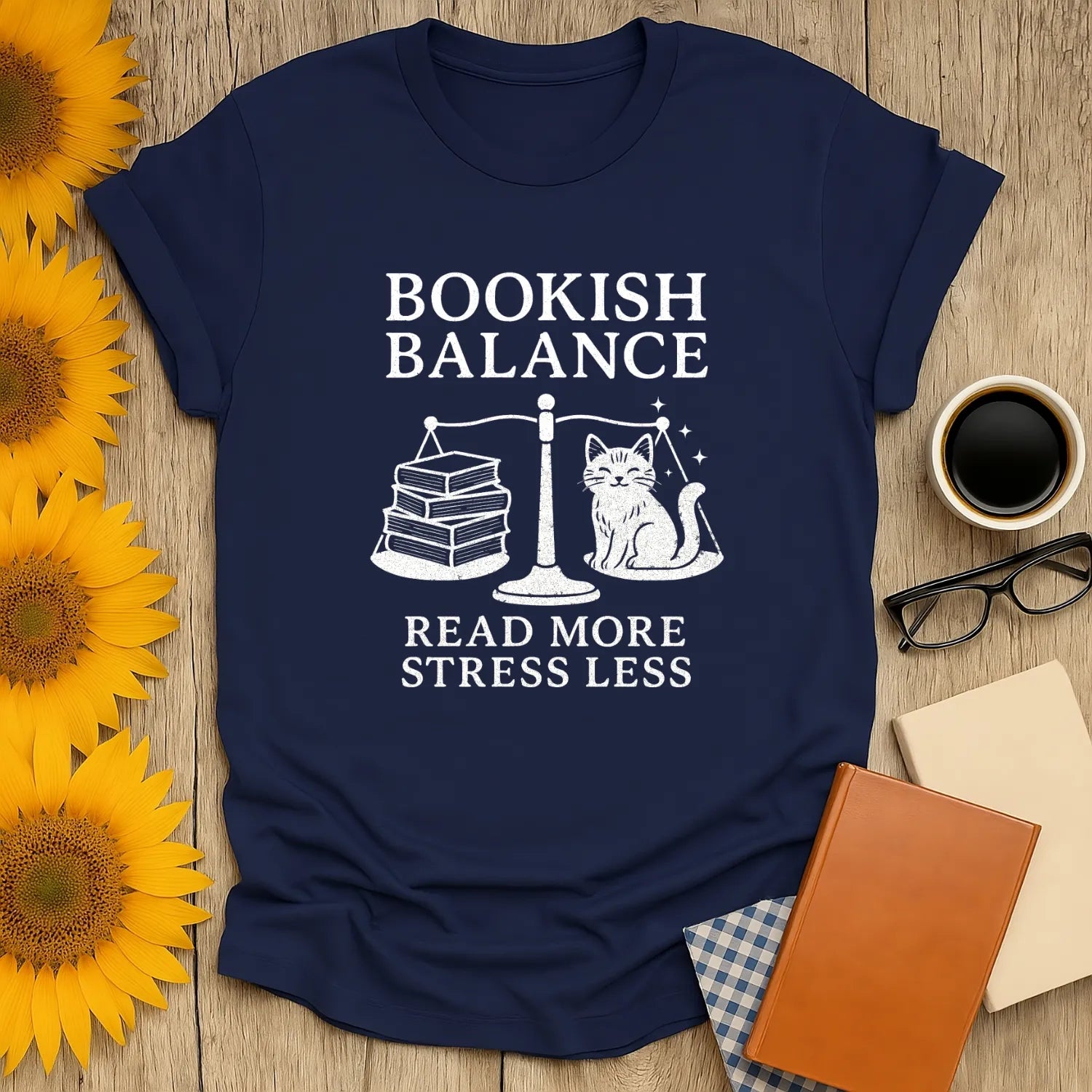 Navy Bookish Balance tee featuring a cat, books on a scale, and text 'Read More Stress Less'—a cozy gift for book lovers!