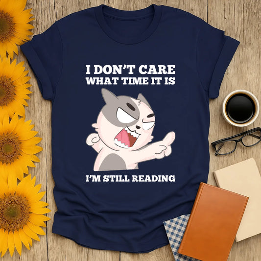 Funny cat graphic tee saying 'I don't care what time it is, I'm still reading' – perfect for book lovers and cozy reading vibes.