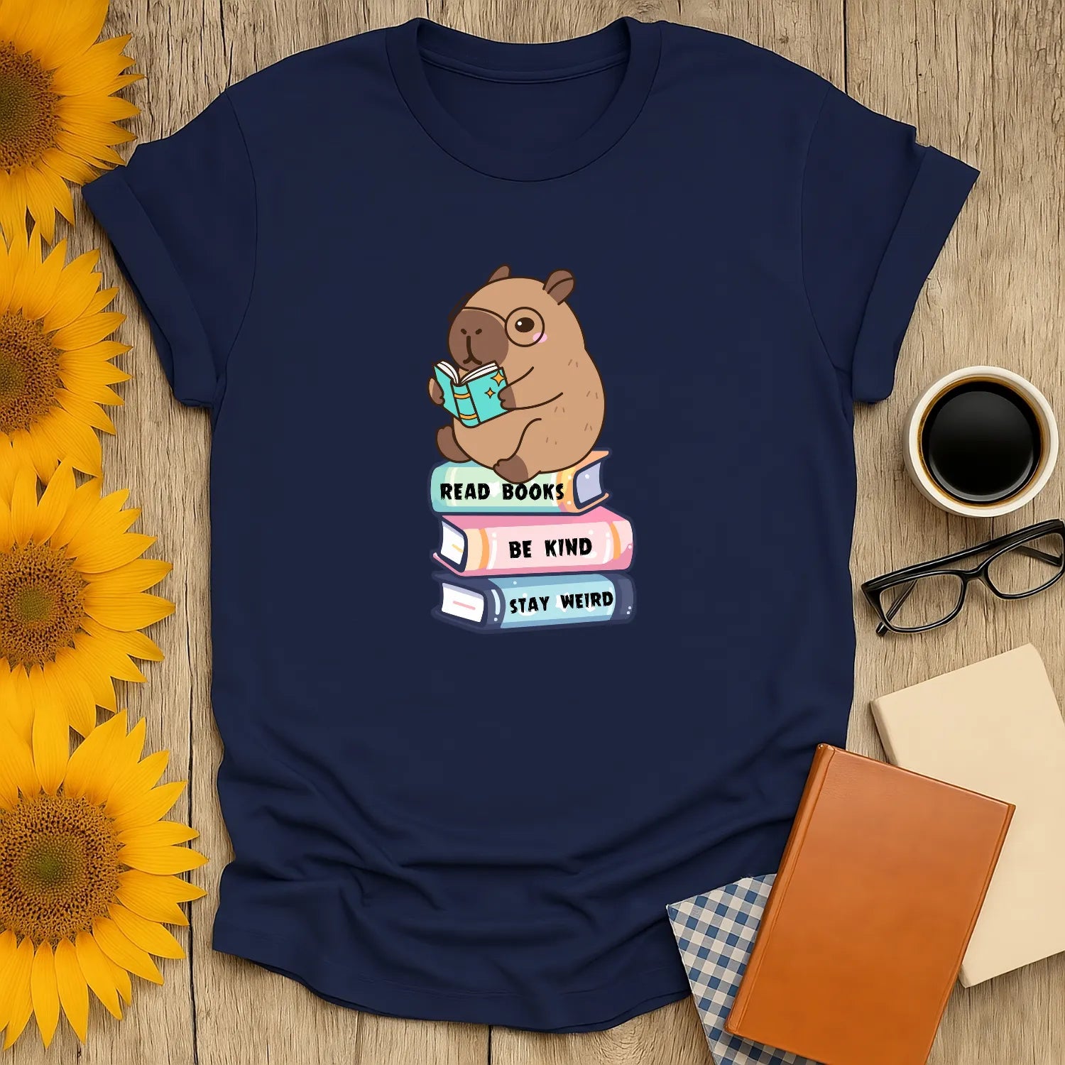 Capybara Reader T-Shirt featuring a cute capybara reading on a stack of books, perfect for book lovers and introverts. 📖