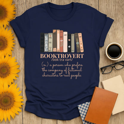 Navy Booktrovert T-shirt with books illustration and witty text, perfect gift for cozy book lovers, cats, coffee, and tea.