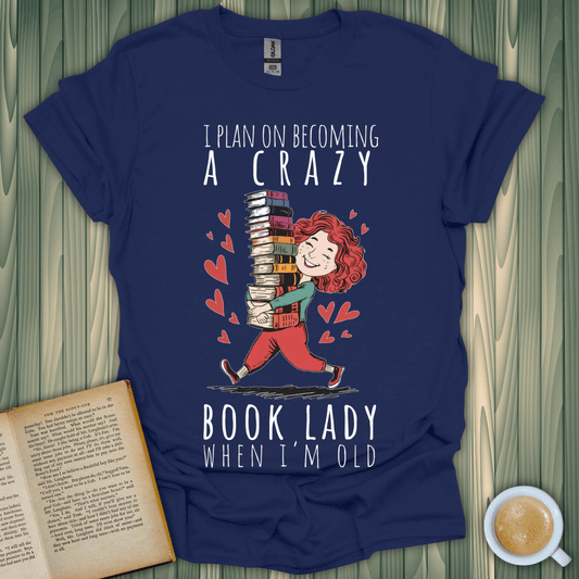 Funny book lover t-shirt with cartoon design: 'I plan on becoming a crazy book lady when I'm old'.