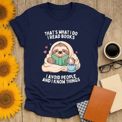 Sloth reading a book on a navy t-shirt with the phrase 'I avoid people and I know things' for book lovers.