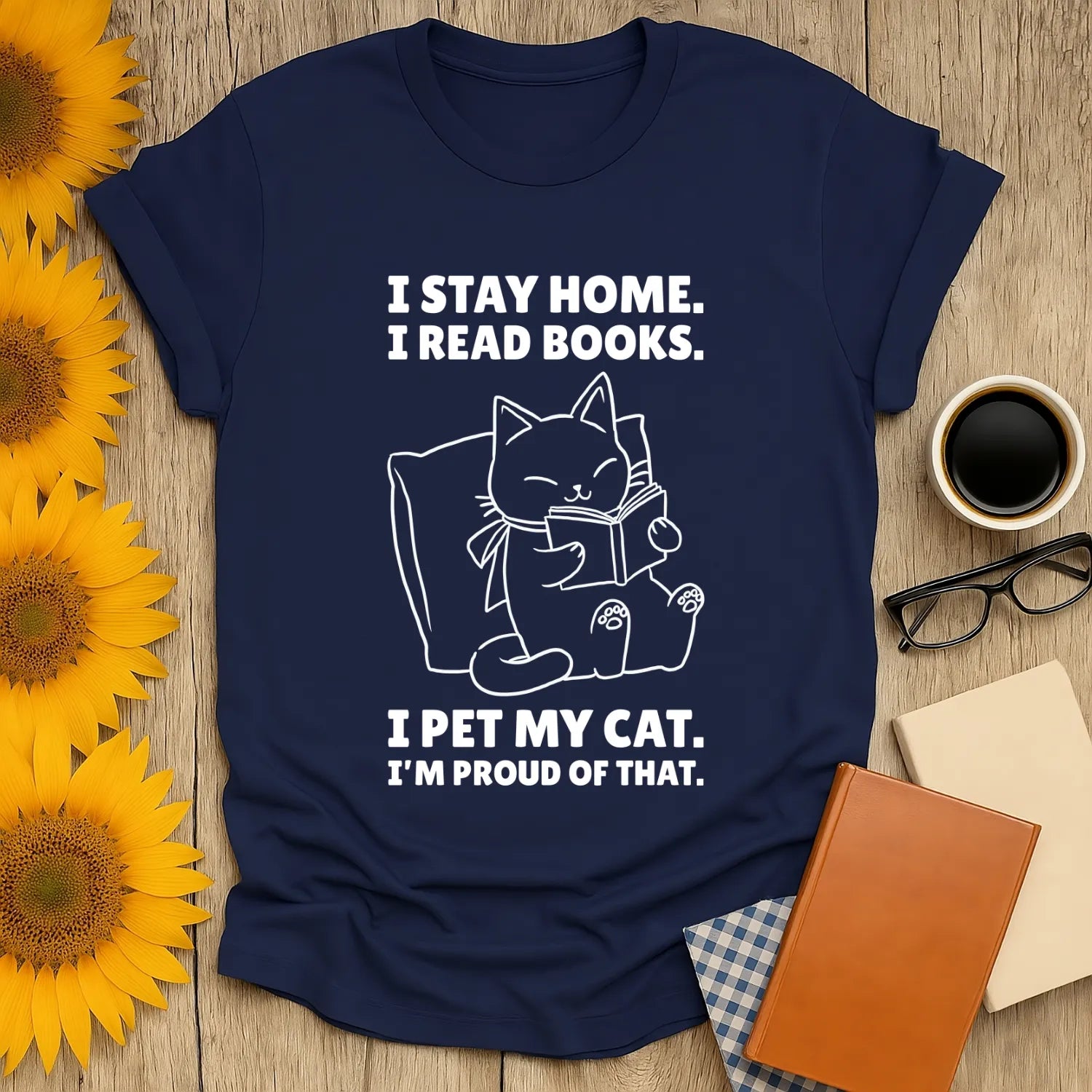 Cozy cat reading shirt: features a cat with a book, saying "I stay home. I read books. I pet my cat. I'm proud of that." Perfect for book lovers!