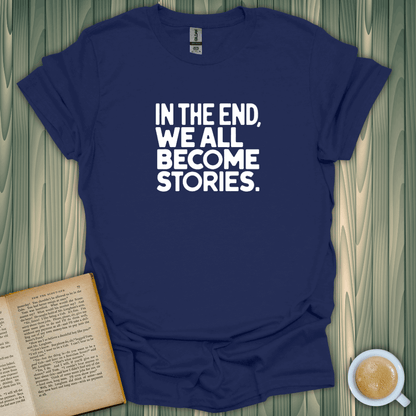 Navy blue 'We All Become Stories' T-shirt, 100% cotton, perfect for book lovers.