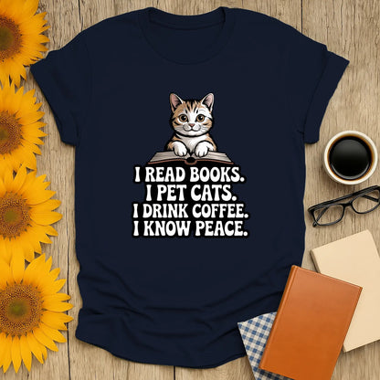 Funny reading tee featuring a cute cat with text: 'I READ BOOKS. I PET CATS. I DRINK COFFEE. I KNOW PEACE.' Perfect gift for book lovers!