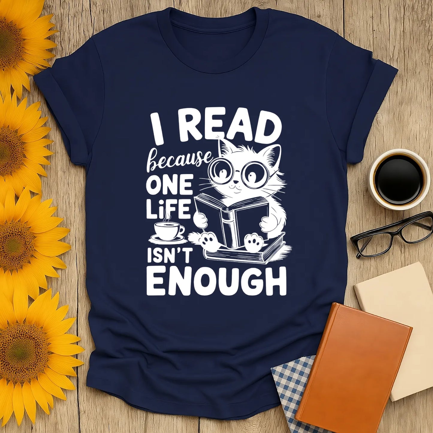 Navy T-shirt featuring a cute cat reading a book with the text: 'I READ because ONE LIFE ISN'T ENOUGH', perfect for book lovers.