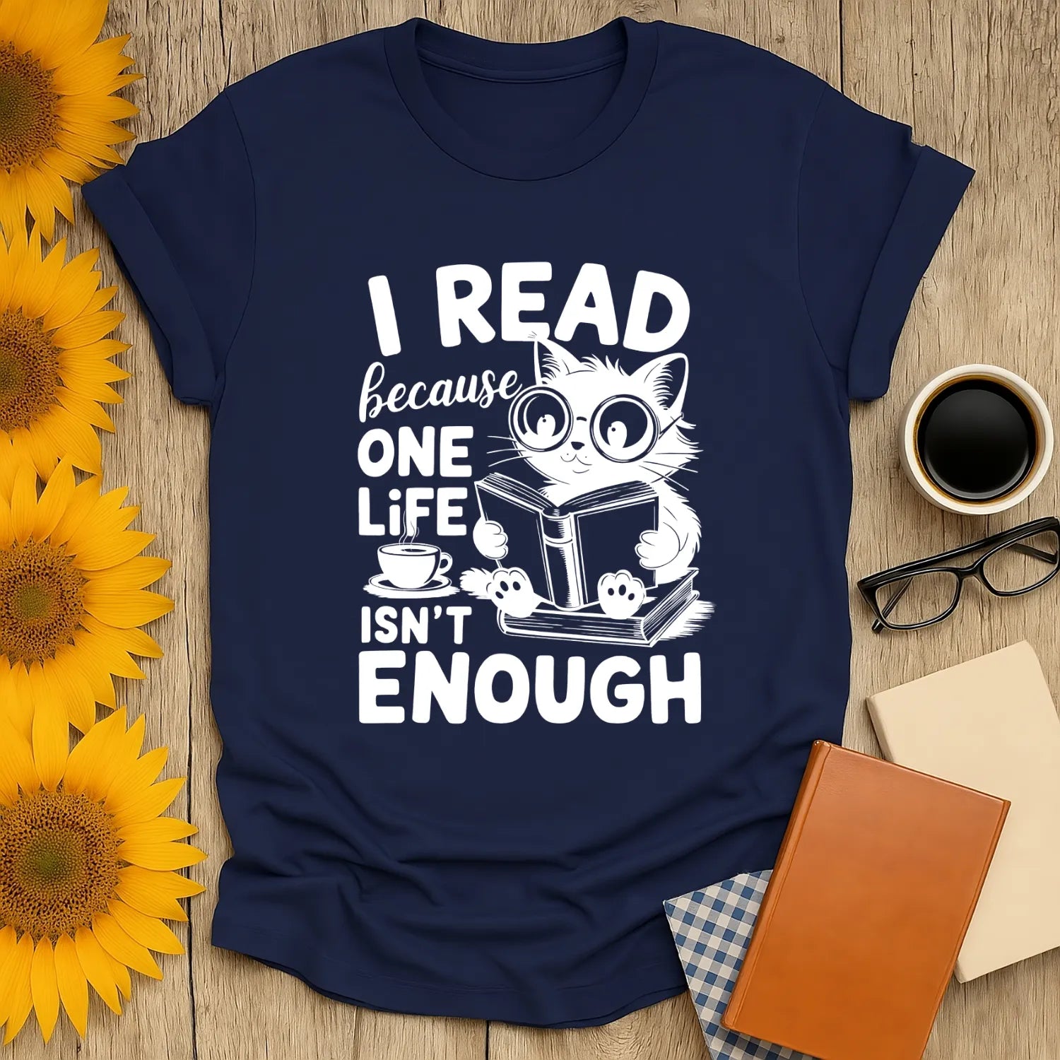 Navy T-shirt featuring a cute cat reading a book with the text: 'I READ because ONE LIFE ISN'T ENOUGH', perfect for book lovers.