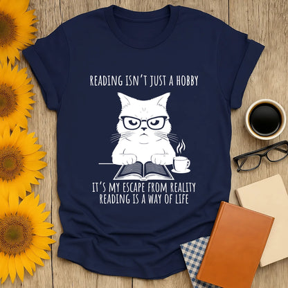 Funny cat reading shirt with text: 'Reading isn’t just a hobby, it’s my escape from reality.' Perfect for book lovers!