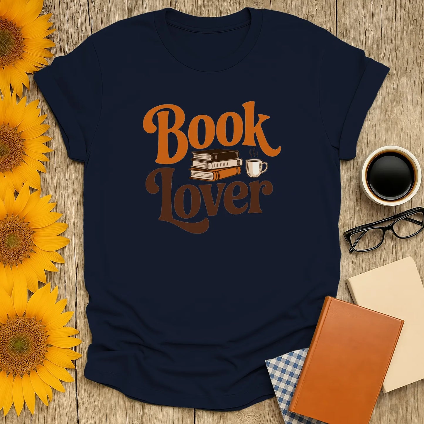 Cozy navy book lover t-shirt with stacked books and a coffee cup, perfect gift for readers and cat lovers.