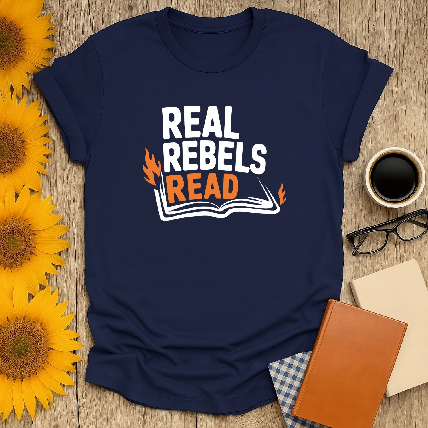 Real Rebels Read T-Shirt featuring bold text and an open book, perfect for book lovers who adore cats, coffee, or tea.